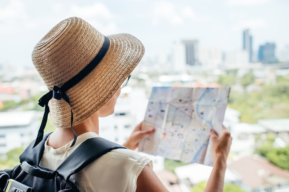 Solo female traveler choosing her travel destination