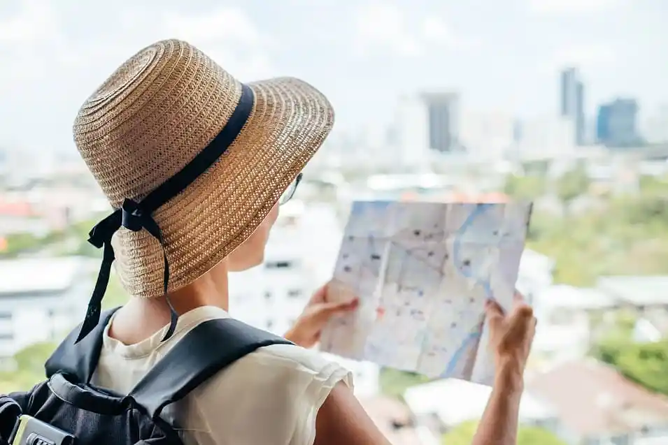 Solo female traveler choosing her travel destination